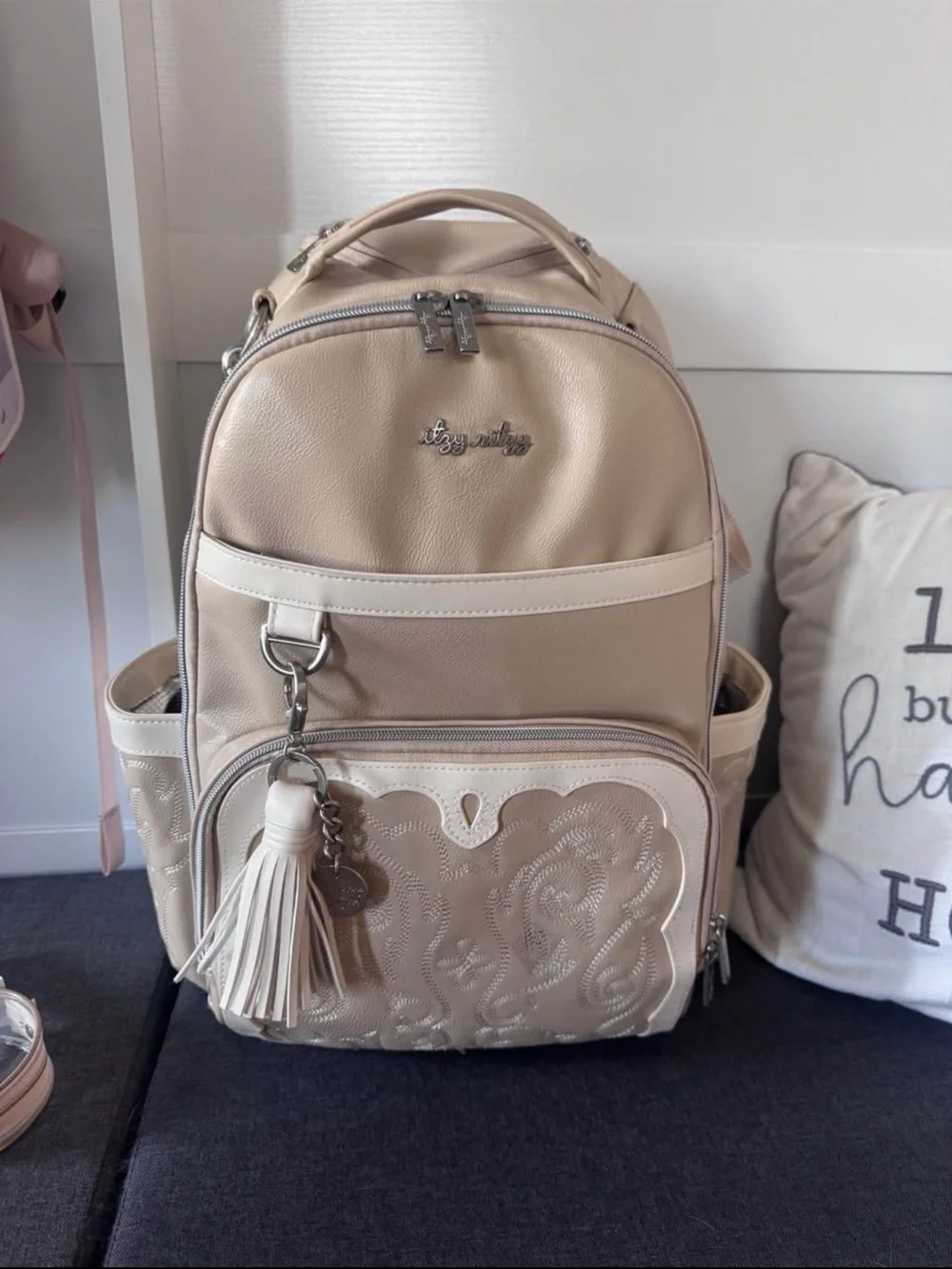 Itzy Ritzy Beige Cream Baby Bag Backpack with Tassel Charm
